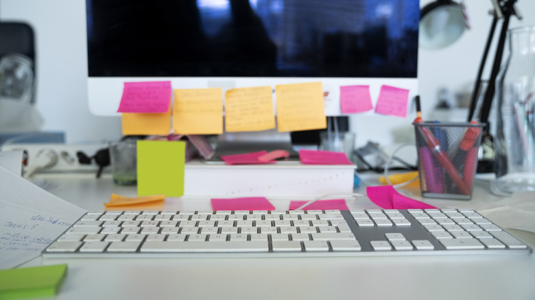 A desk setup cluttered with different items