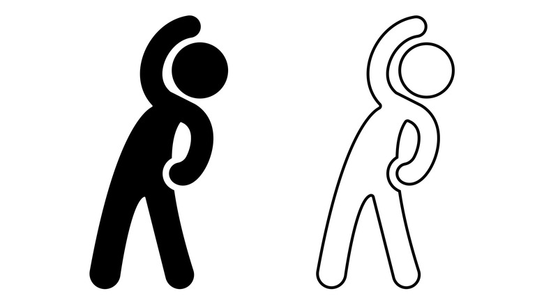 Woman stretching while working on a computer