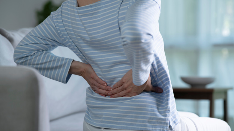 Woman sitting on an office chair with proper lumbar support