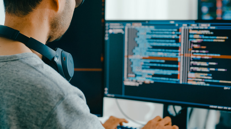 Programmer viewing a monitor at eye level