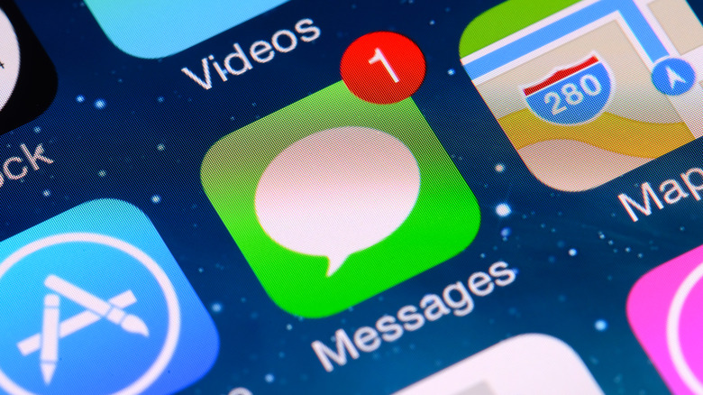Apple messages app on iPhone screen with other apps around it