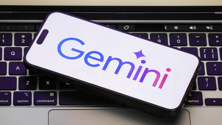 Gemini logo on iPhone sitting on Macbook keyboard