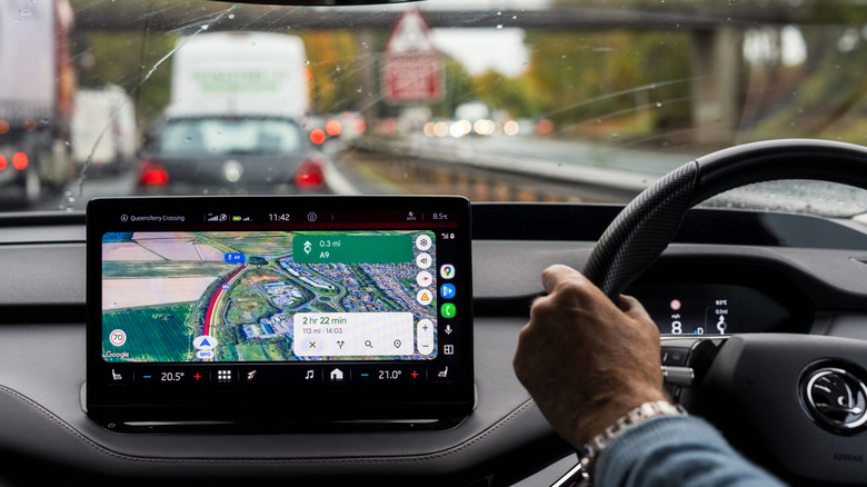 Google Maps on a display in a vehicle showing a possible delay