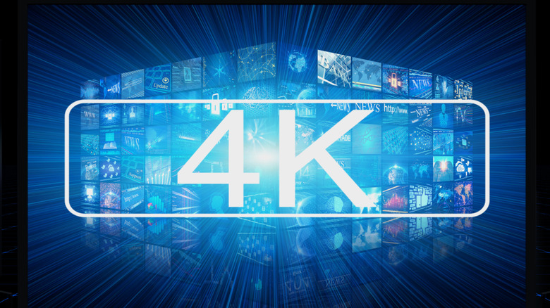 A 4K logo imposed over a wall of screens displaying various types of content
