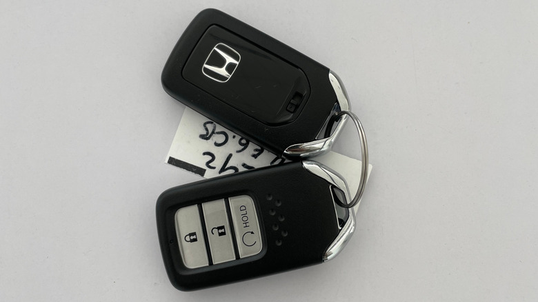 honda car keys placed on a white surface