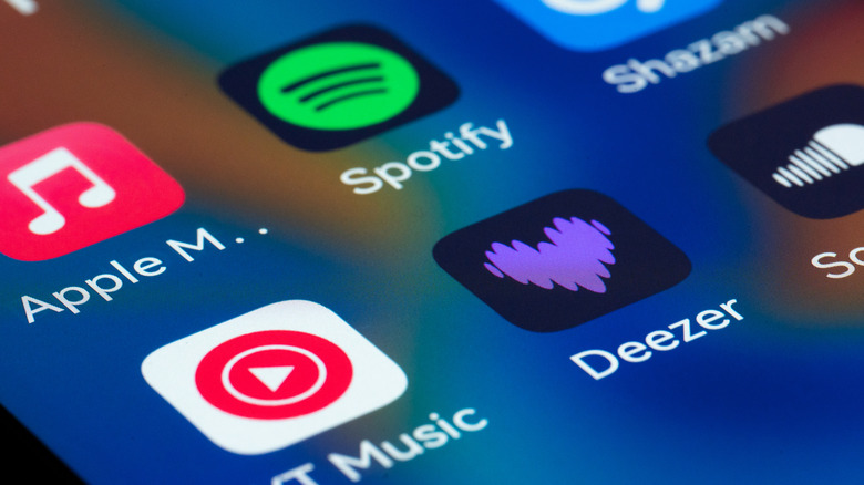 Streaming music service app icons visible close up on a phone screen.