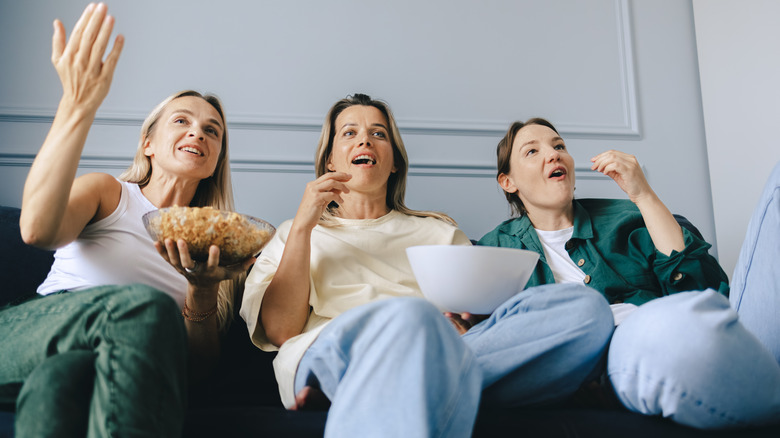 women watching tv with popcorn