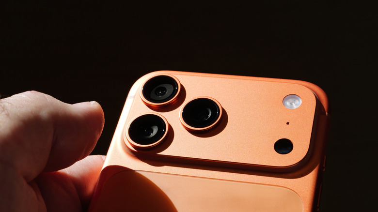 An iPhone 17 Pro showing its rear camera lenses and LED flash light