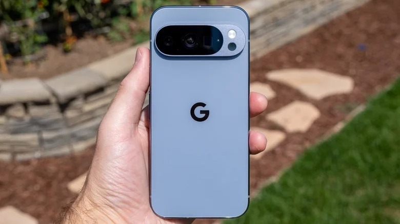 A hand holding a Google Pixel 10 Pro outside
