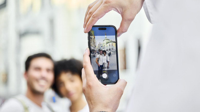 Person taking a photo with an iPhone