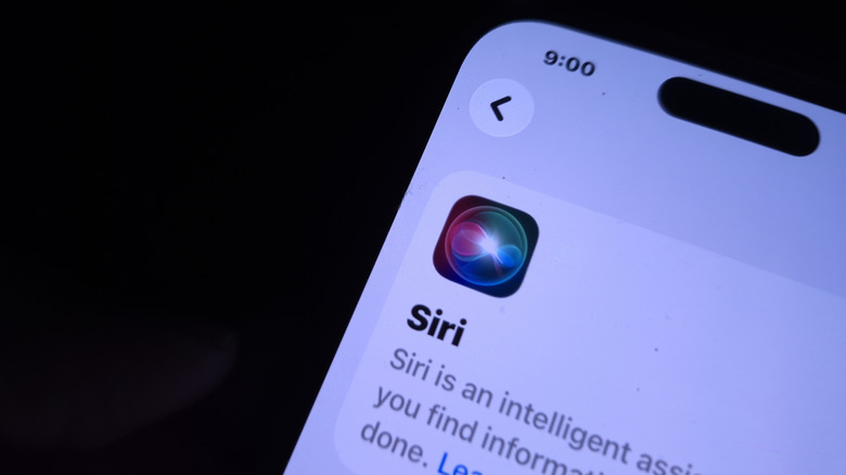 IPhone displaying Siri in front of a black background