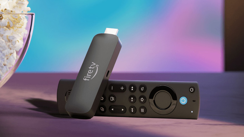 An Amazon Fire TV Stick 4K Max with the remote and a bowl of popcorn.