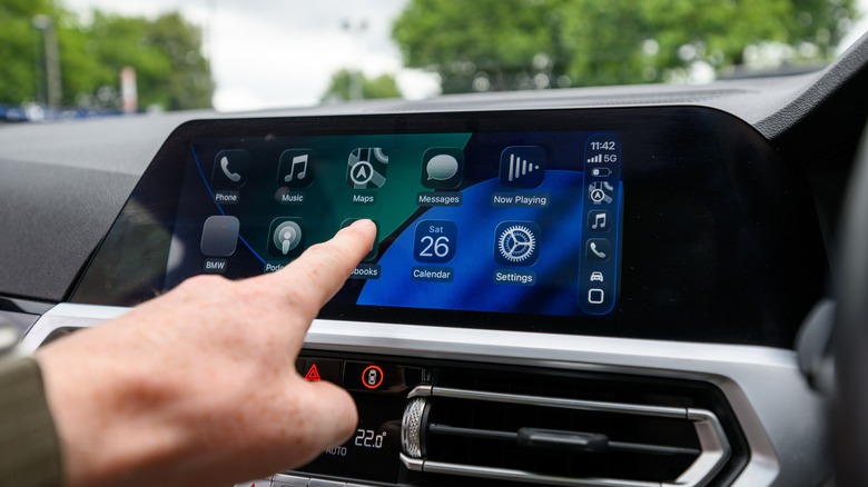 Apple CarPlay on a vehicle's infotainment screen displaying the new Liquid Glass design.