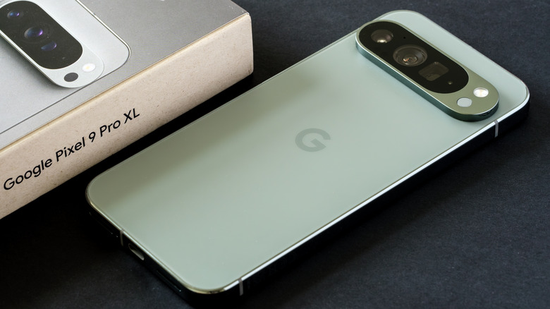 A Google Pixel 9 Pro XL placed next to its box.