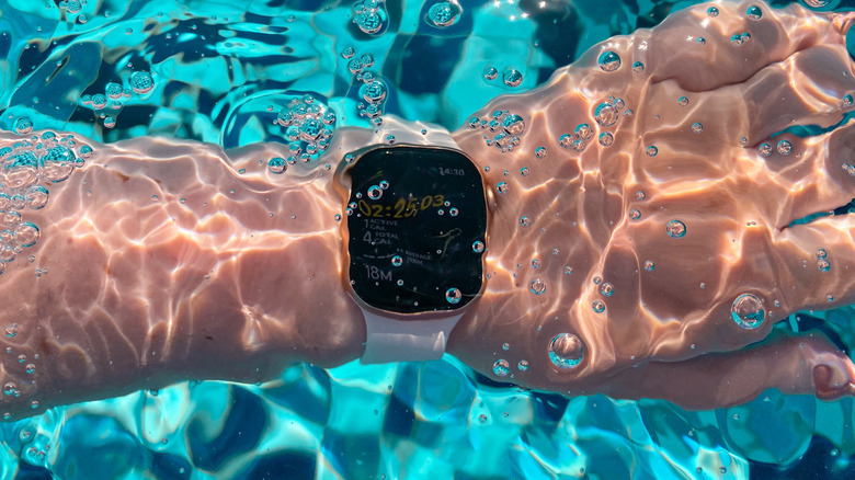 A person wearing an Apple Watch under water