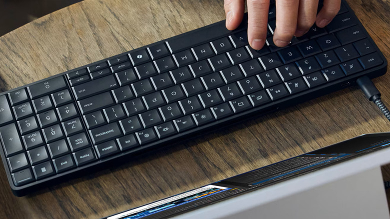 A person typing on the HP EliteBoard