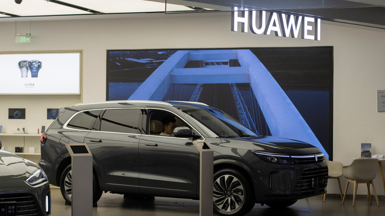 a person sits in a vehicle at the Huawei dealership