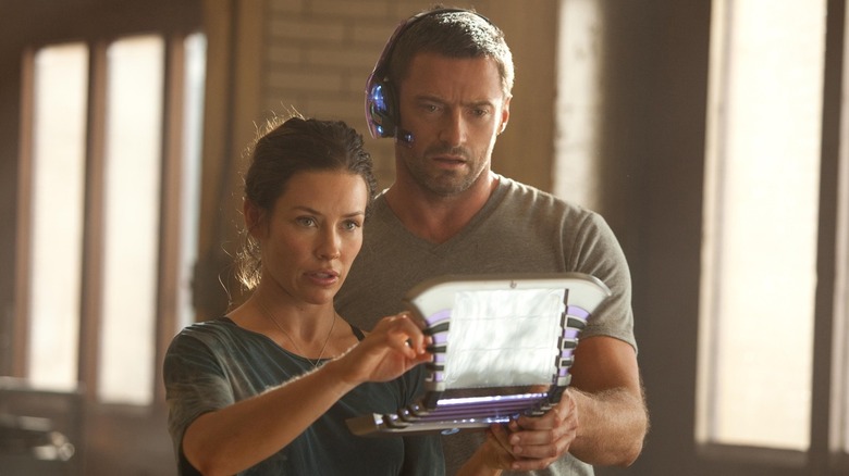 Evangeline Lilly and Hugh Jackman looking at a computer screen in Real Steel