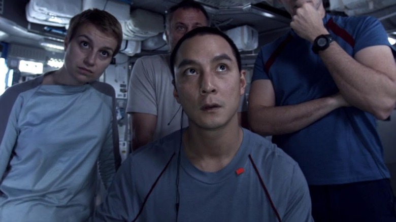 Anamaria Marinca, Daniel Wu, Michael Nyqvist and Sharlto Copley looking at a monitor in Europa Report