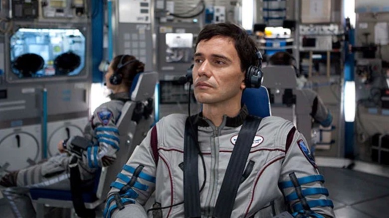 Christian Camargo as Daniel Luxembourg strapped into a seat on a spaceship in Europa Report