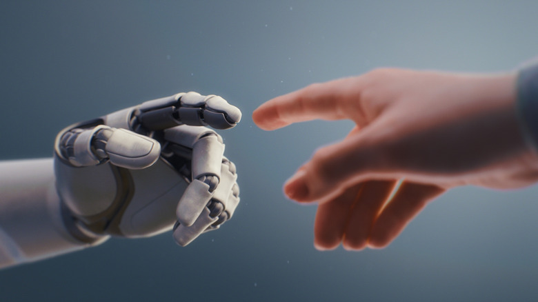 Robot hand reaching out finger to human hand