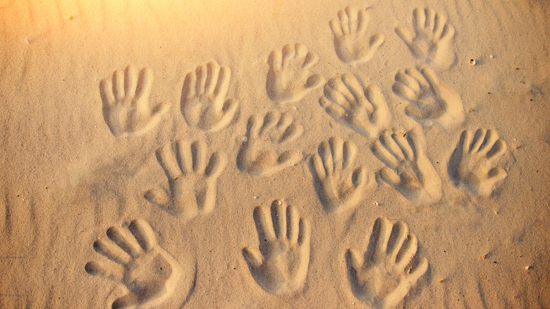 human handprints in the sand