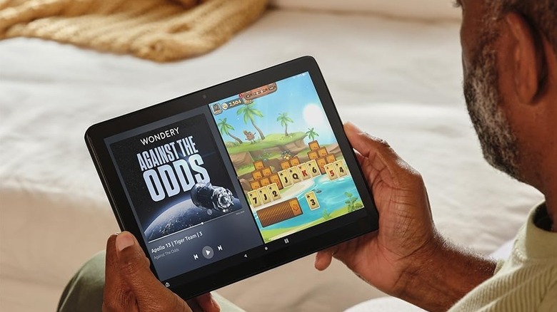 A person enjoying a podcast and a game on Fire HD 10