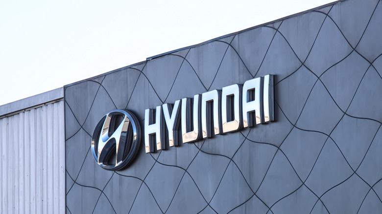 The Hyundai logo on a car dealership in Spain.