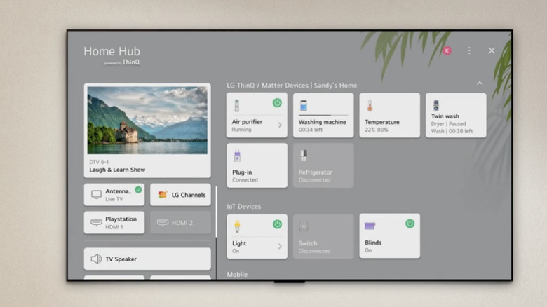 A wall-mounted LG TV displaying the webOS Home Hub screen.