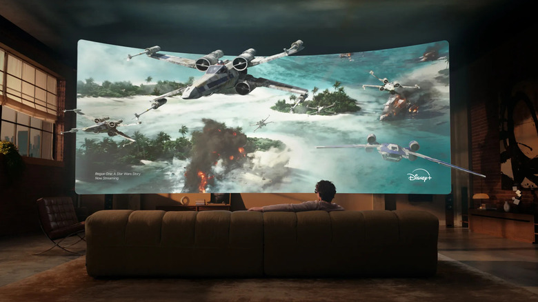 A man watching Disney+ on the Meta VR glasses from his couch, with the virtual display blown up