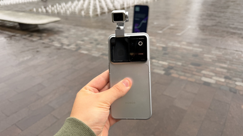 Honor's Robot Phone being held in hand with the gimbal extended