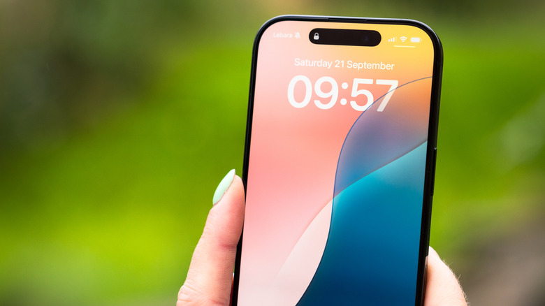 User holding an iPhone 16 Pro