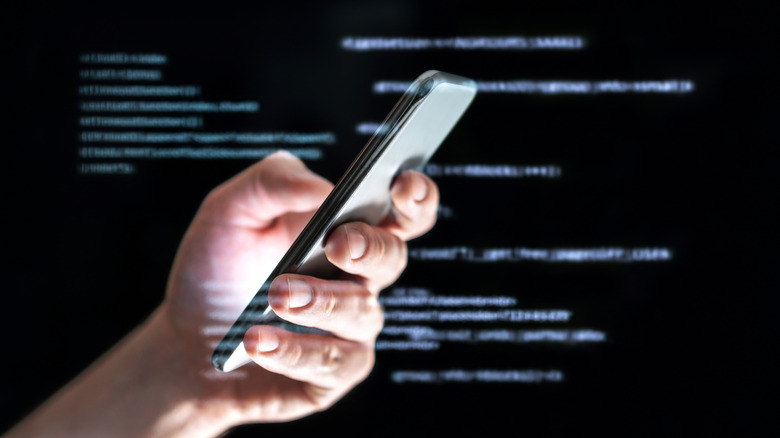 concept photo of hacker using a smartphone