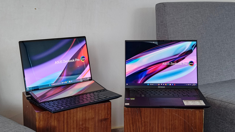 Two Asus ZenBook Pro laptops on tables