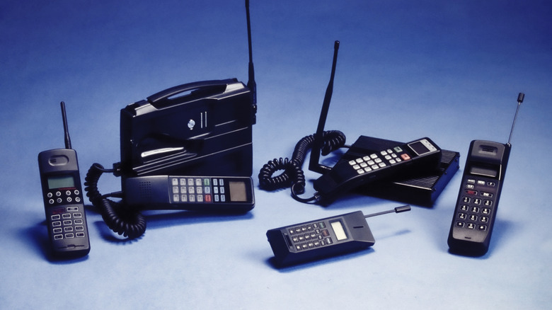 Multiple vintage cellphones.