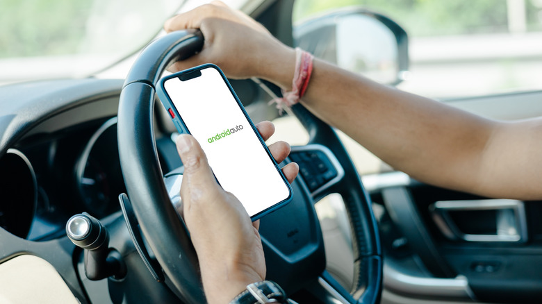 Person connecting to Android Auto between their phone and their vehicle.