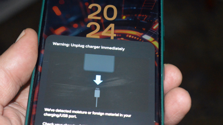 warning to unplug charger immediately because of moisture or foreign material detection