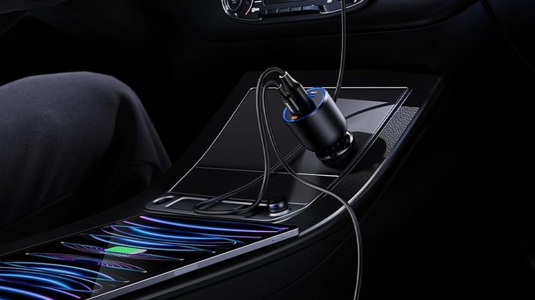 A Ugreen 12V car charger connected to a center console port.