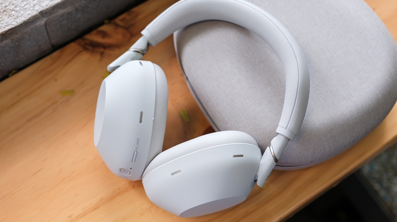 The Sony WH-1000XM6 next to their hardshell carrying case.