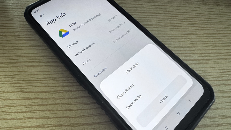Android phone on table showing clear cache option for Google Drive