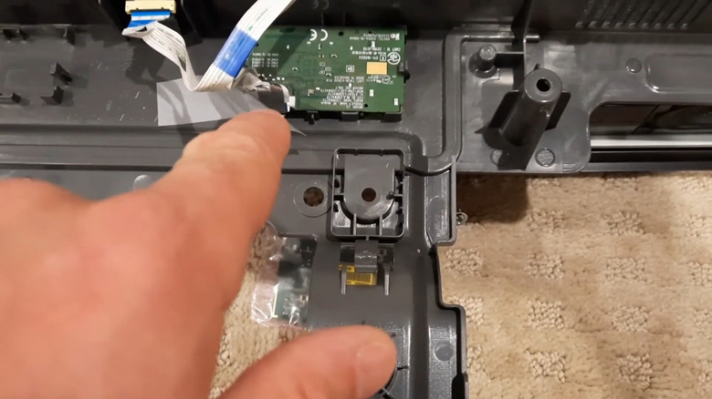 Hand pointing to LG TV Wi-Fi module