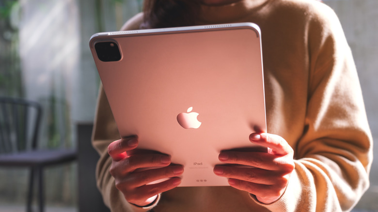 A person holding an iPad