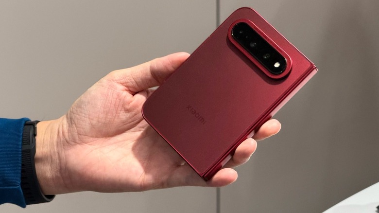 A hand holding Xiaomi's new 18 Fold phone