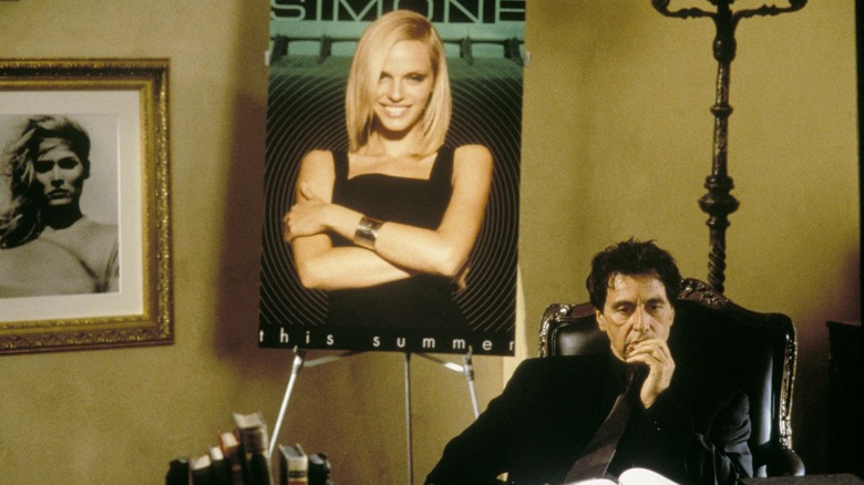 Viktor Taransky sitting in his office before a poster of Simone, thinking
