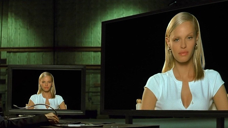 Simone on several computer screens, looking at the viewer