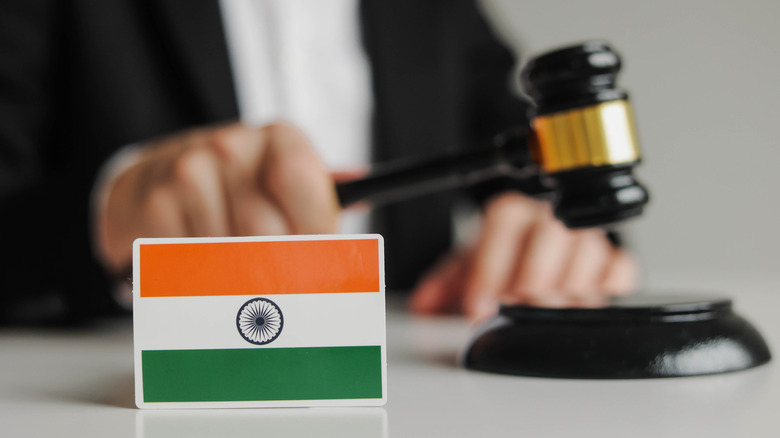 the India flag with a legal gavel and a judge behind it