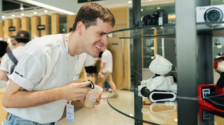 A man looking at the Ai security camera robot
