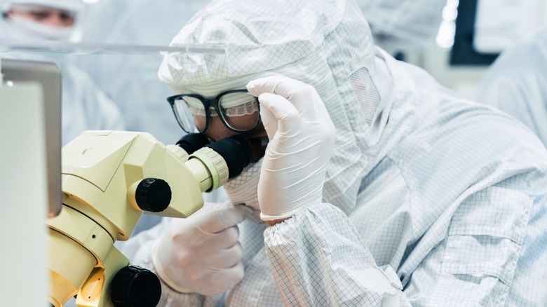 A woman using a microscope