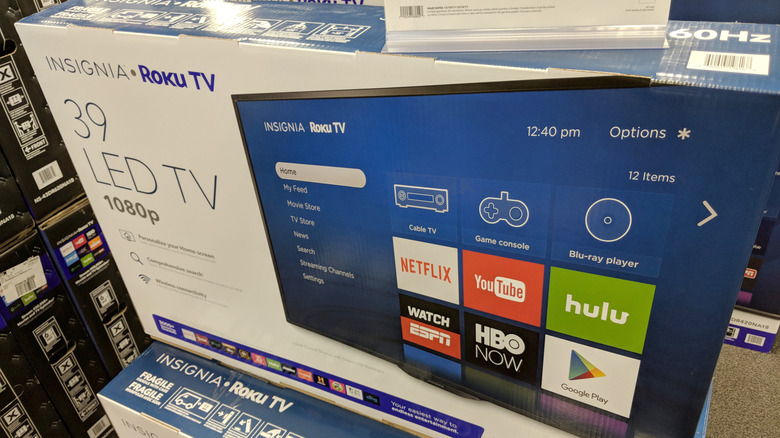 An Insignia Roku TV in a box in a Best Buy store.