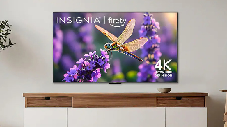 An Insignia Fire TV mounted on a wall.